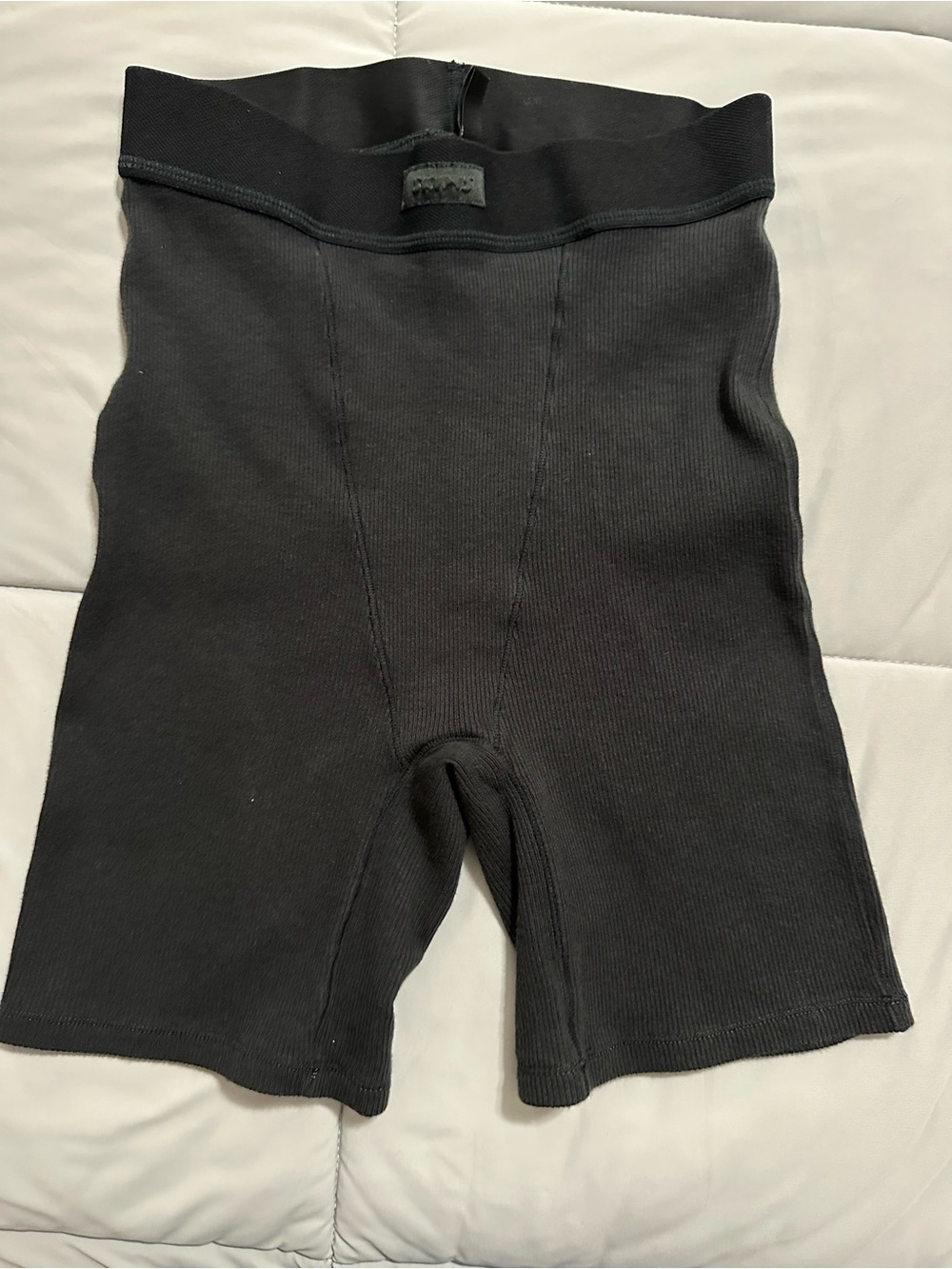 SKIMS Cotton Rib lounge shorts in the color Soot.